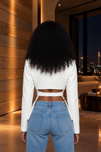 Bleu Hanger ivory tailored blazer with statement waist cutouts and structured shoulders, back view on a model.