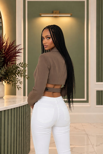 Bleu Hanger mocha-brown cropped blazer with waist cutouts and back button detail worn by a woman with long braids.