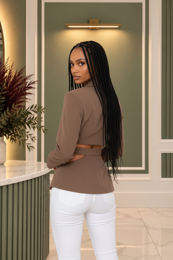 Model wearing a Bleu Hanger mocha-brown tailored blazer with waist cutouts and asymmetrical wrap-front design